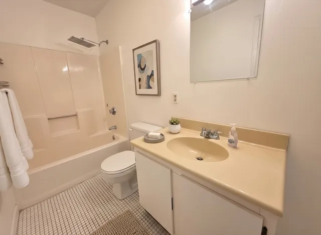 a living room with furniture and a ceiling fan