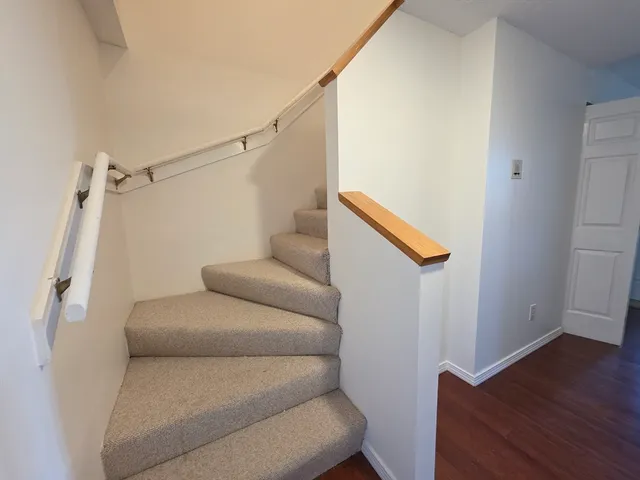 a living room with furniture wooden floor and a flat screen tv