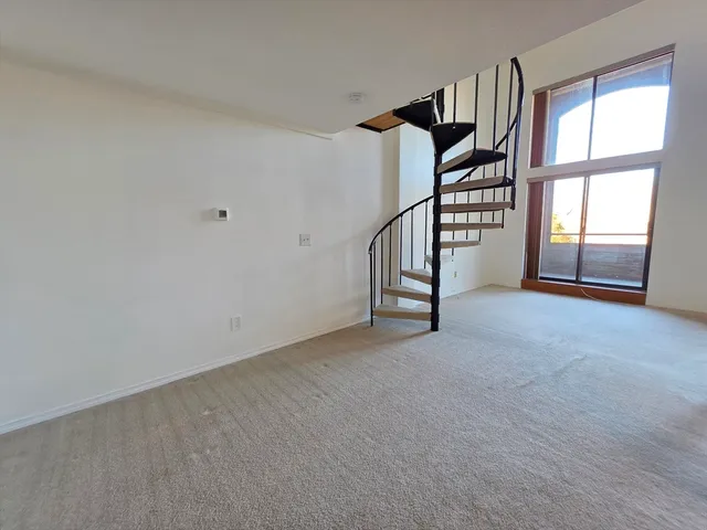 a view of a balcony with floor to ceiling windows with wooden floor
