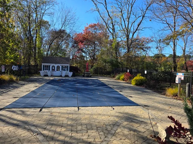 a swimming pool with outdoor seating and yard