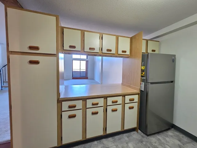 a kitchen with stainless steel appliances a refrigerator and a stove