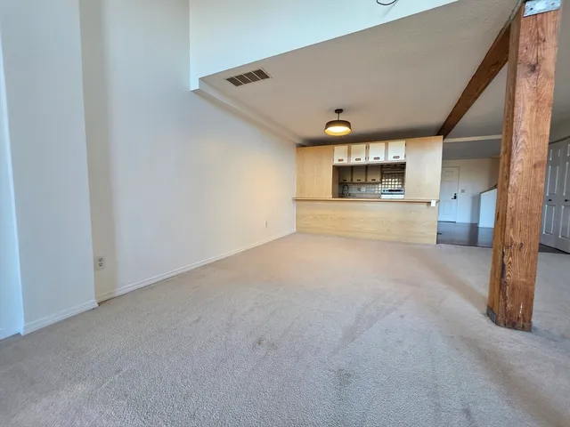 a view of a kitchen with a sink and a refrigerator