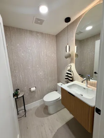 a bathroom with a sink toilet and a mirror