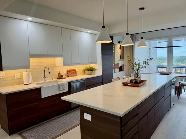 a kitchen with a sink a stove and chairs