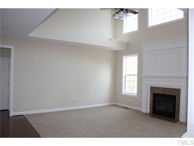 2804 Bending Tree Court Raleigh, NC 27613 - Photo 4 of 25 a view of an empty room with a window and fireplace