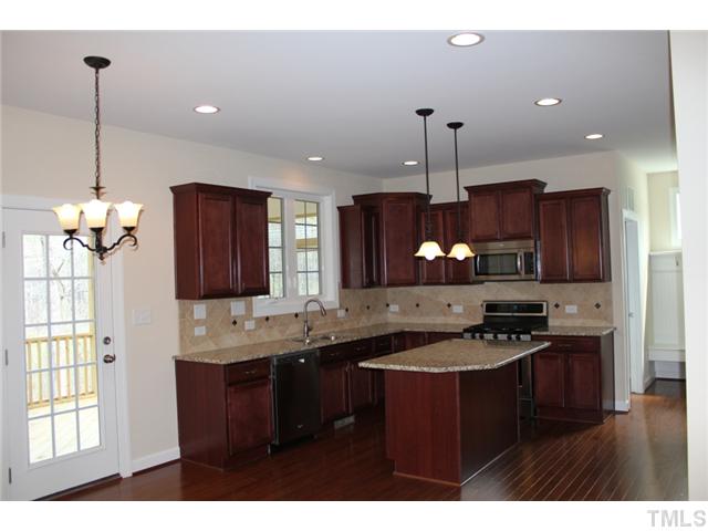 2804 Bending Tree Court Raleigh, NC 27613 - Photo 7 of 25 a kitchen with stainless steel appliances granite countertop a sink stove and refrigerator