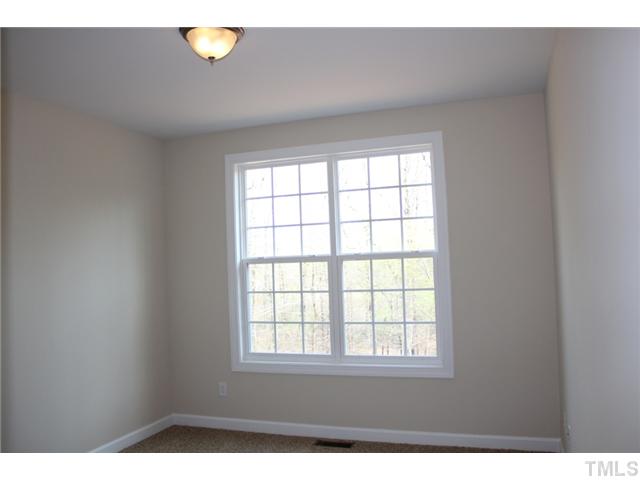 2804 Bending Tree Court Raleigh, NC 27613 - Photo 9 of 25 an empty room with wooden floor and windows