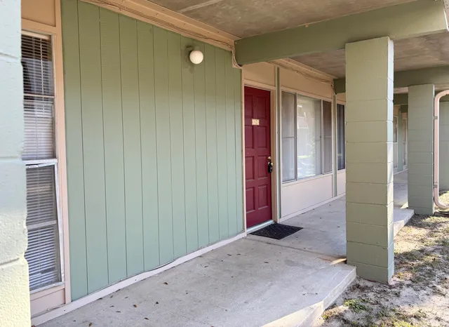 a view of a hallway with wooden shelves