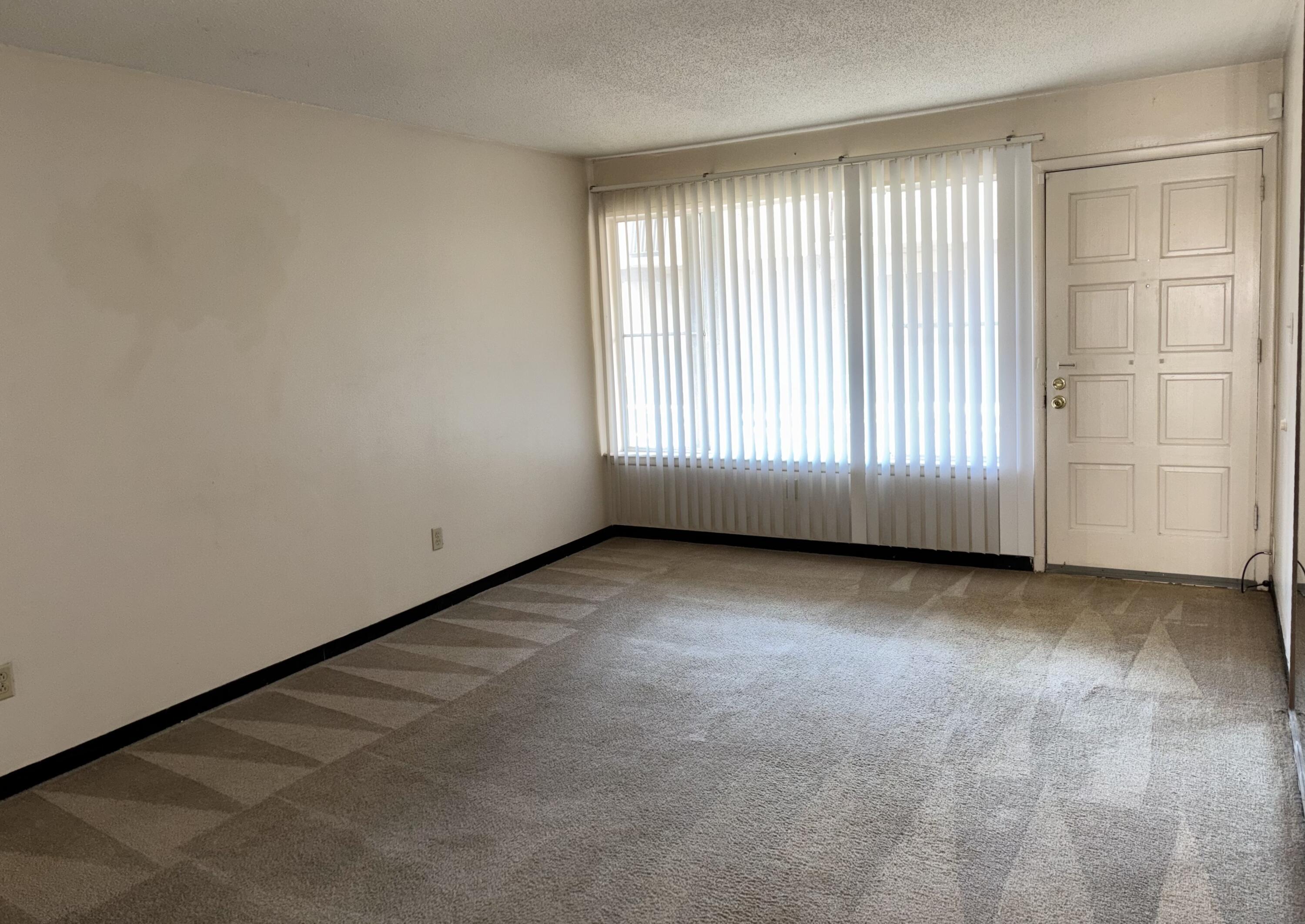 210 Pelham Road, Unit 101B Fort Walton Beach, FL 32547 - Photo 3 of 10 an empty room with windows
