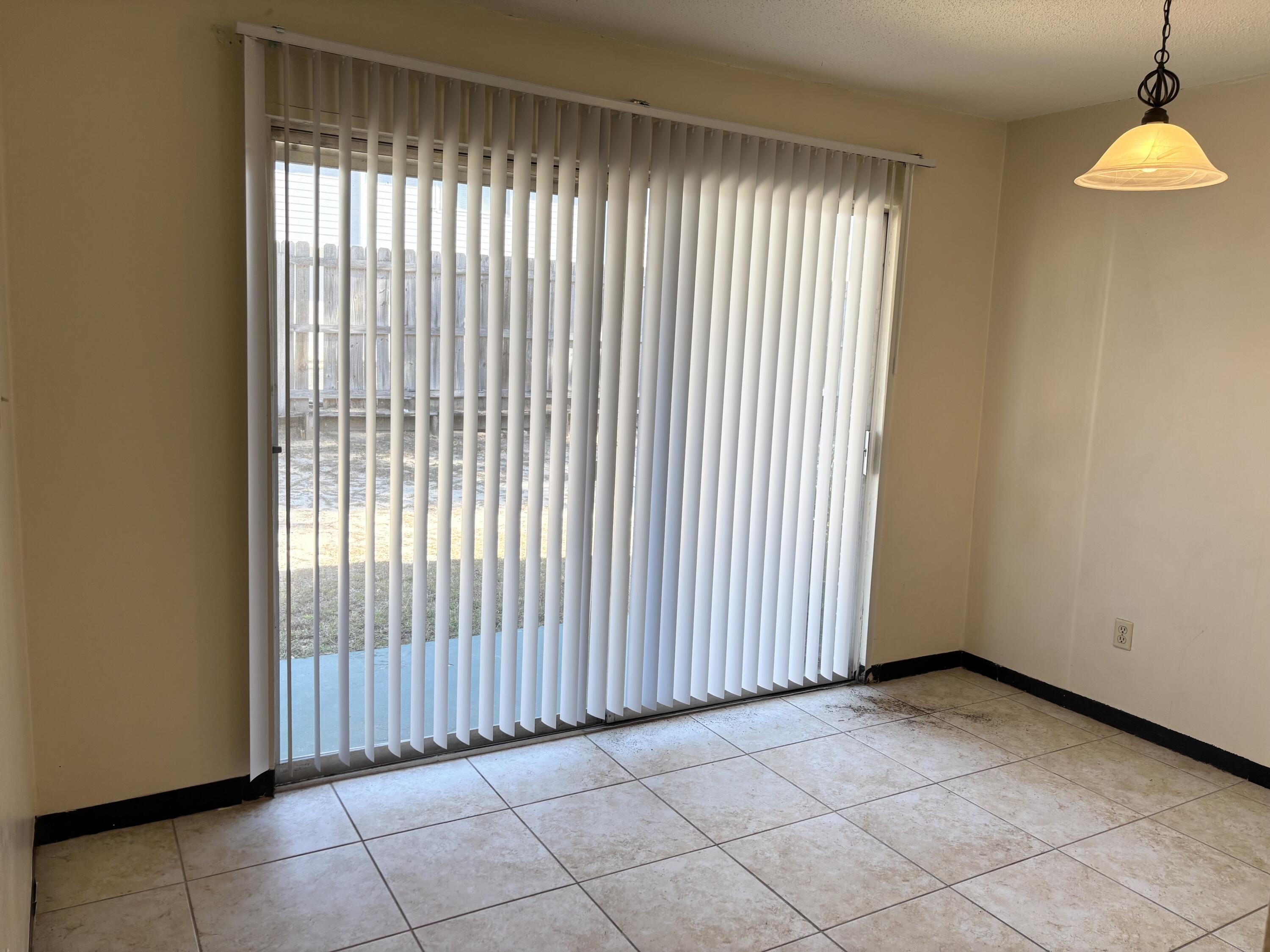 210 Pelham Road, Unit 101B Fort Walton Beach, FL 32547 - Photo 4 of 10 an empty room with windows