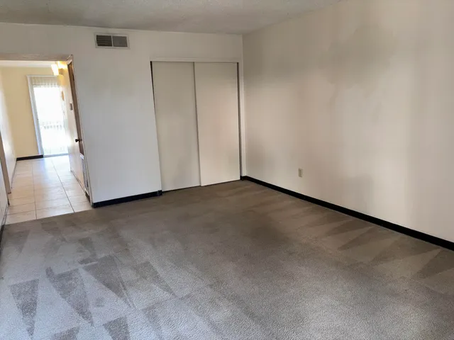 a view of a room with wooden floor