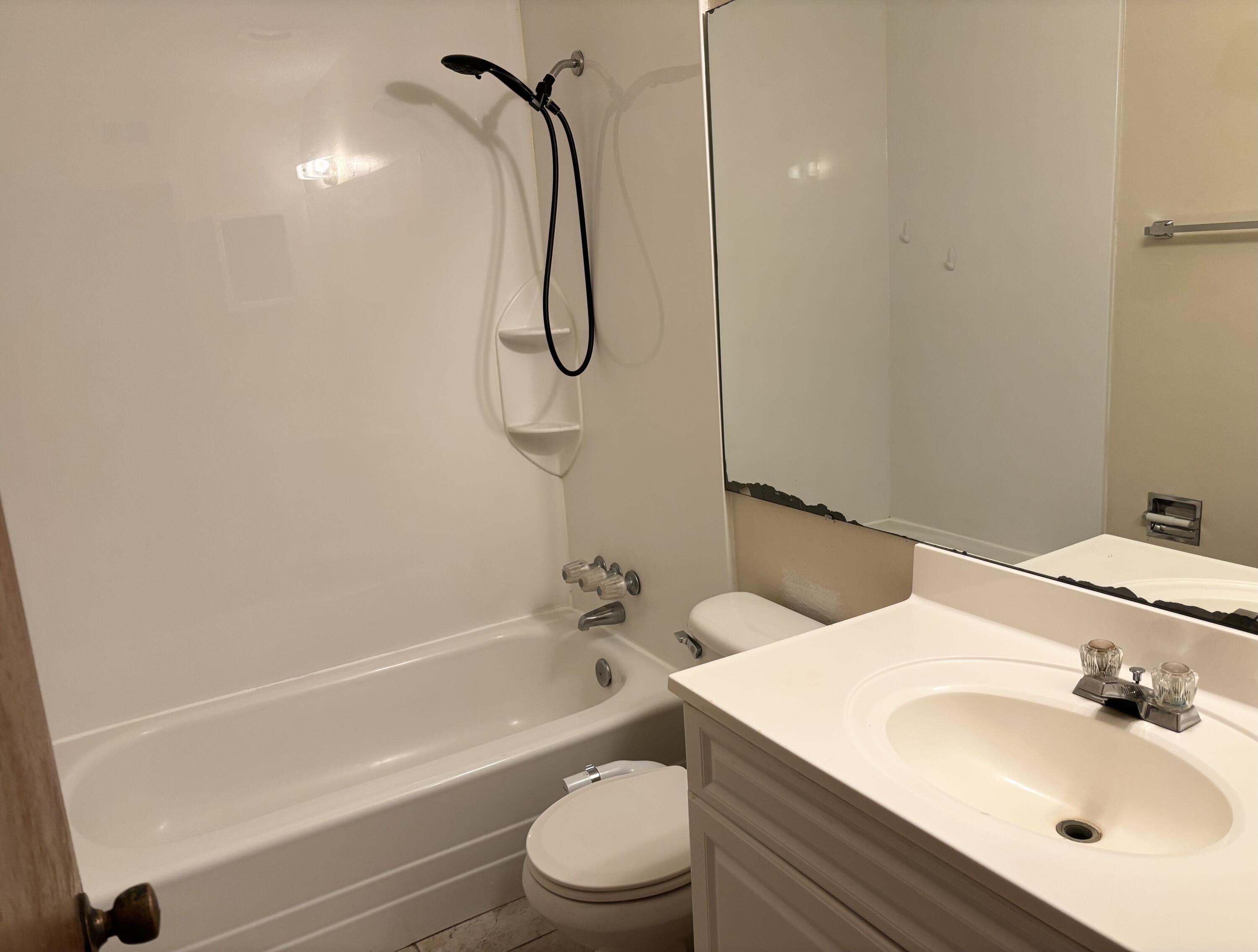 210 Pelham Road, Unit 101B Fort Walton Beach, FL 32547 - Photo 10 of 10 a bathroom with a sink a toilet and shower