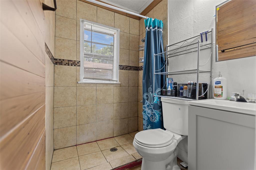 606 North Needmore Street Athens, TX 75751 - Photo 12 of 17 a bathroom with a sink toilet and shower