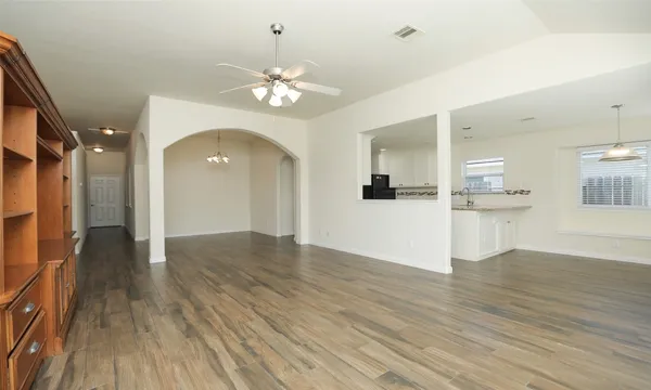 a view of a kitchen with wooden floor and a kitchen