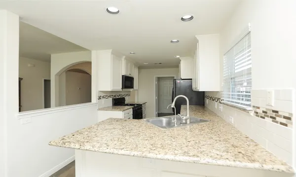 a kitchen with sink and window