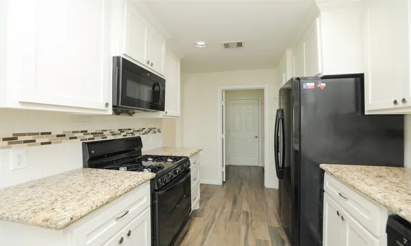 a kitchen with a stove and a refrigerator