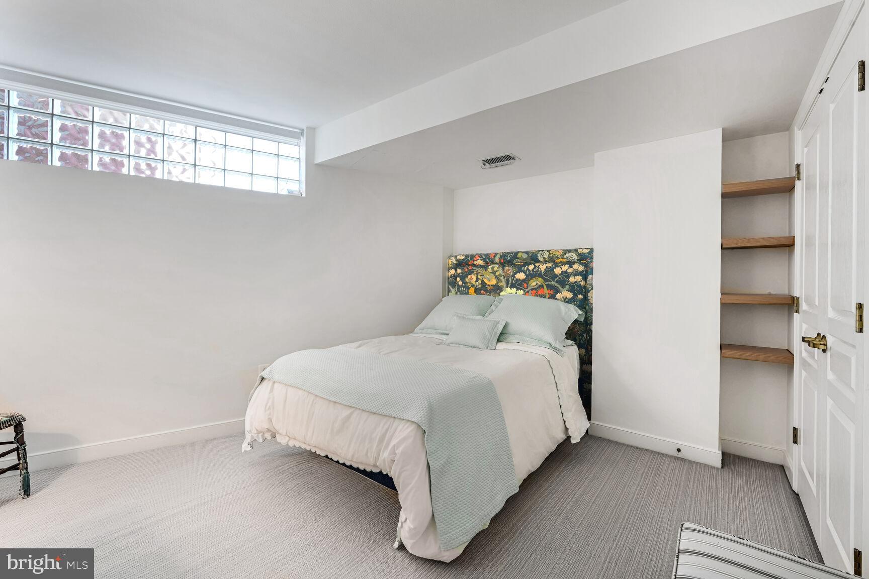 616 E Street Northwest, Unit 1150 Washington, DC 20004 - Photo 20 of 75 a large bed sitting in a bedroom next to a window