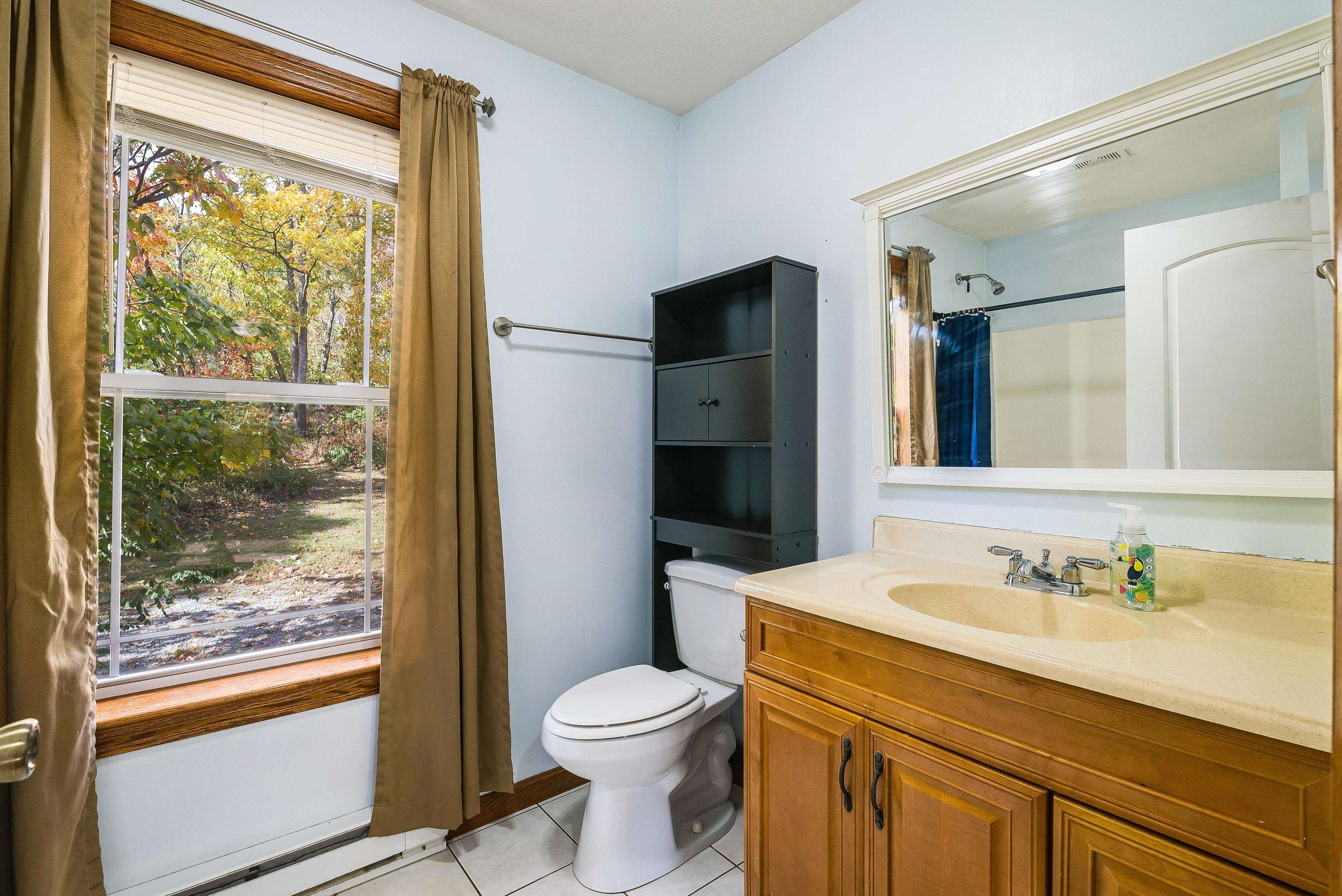8499 Copperhead Road Singers Glen, VA 22850 - Photo 28 of 75 a bathroom with a granite countertop sink toilet and shower
