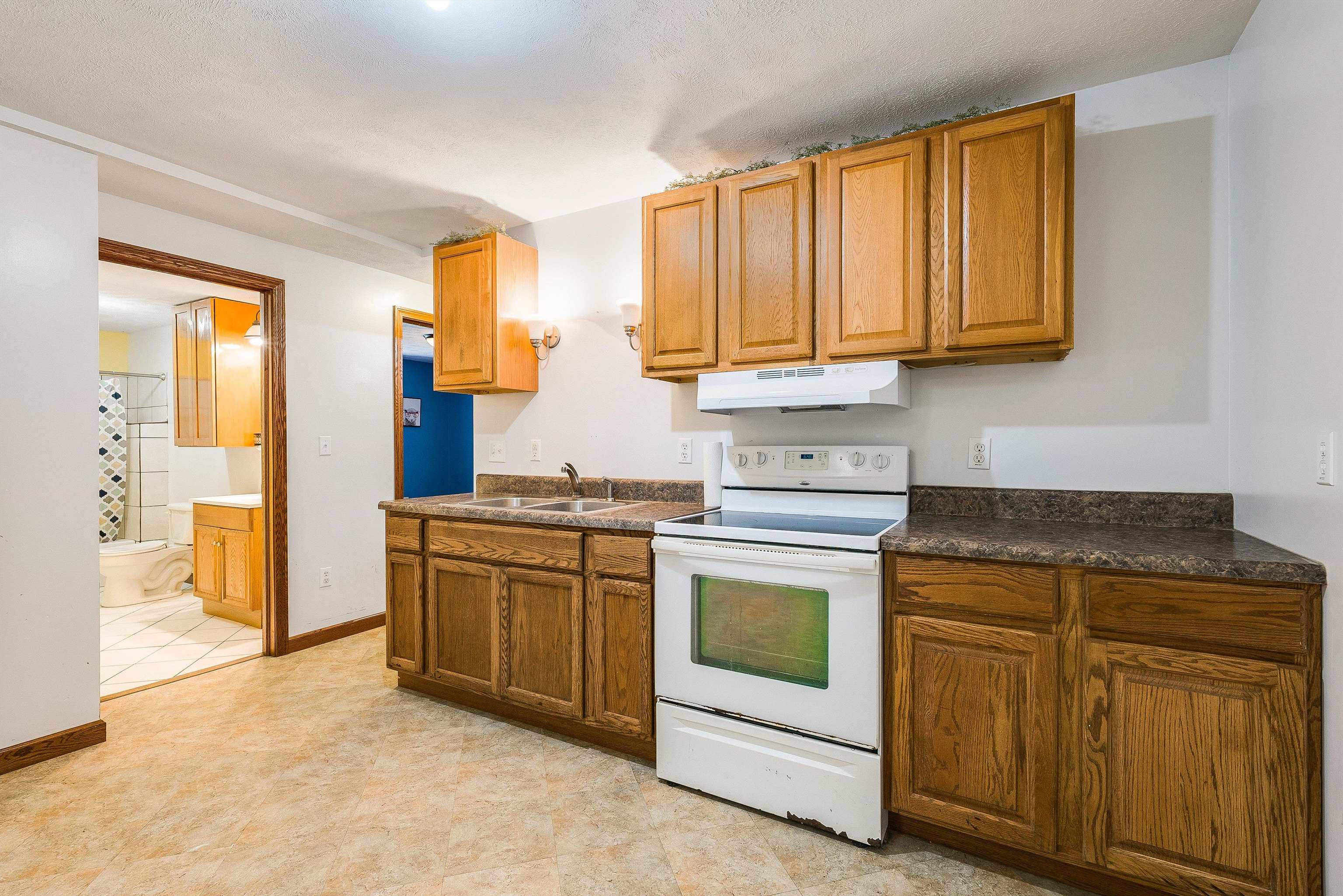 8499 Copperhead Road Singers Glen, VA 22850 - Photo 40 of 75 a kitchen with stainless steel appliances granite countertop a stove a sink and a refrigerator