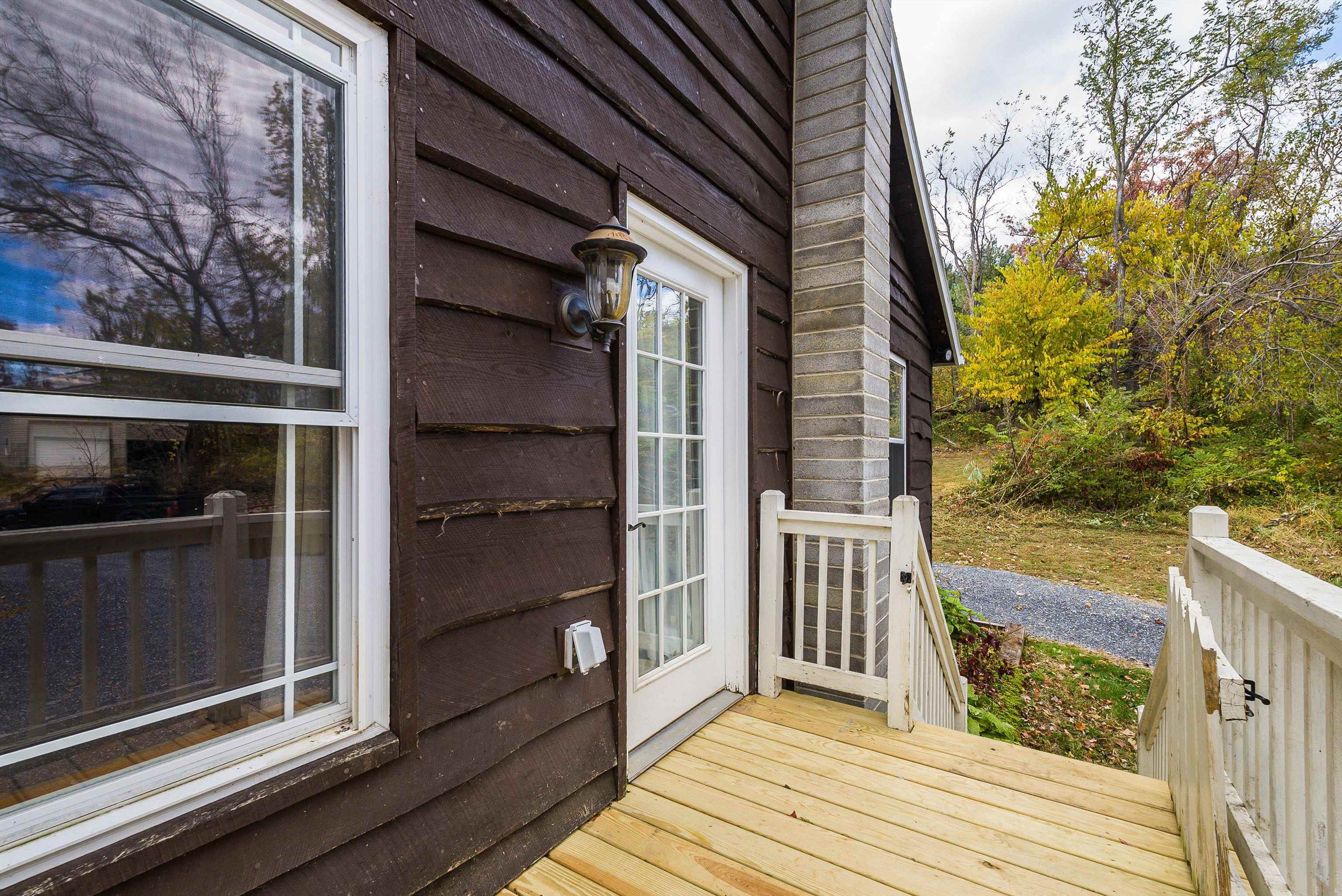 8499 Copperhead Road Singers Glen, VA 22850 - Photo 48 of 75 a view of a balcony with wooden floor and fence