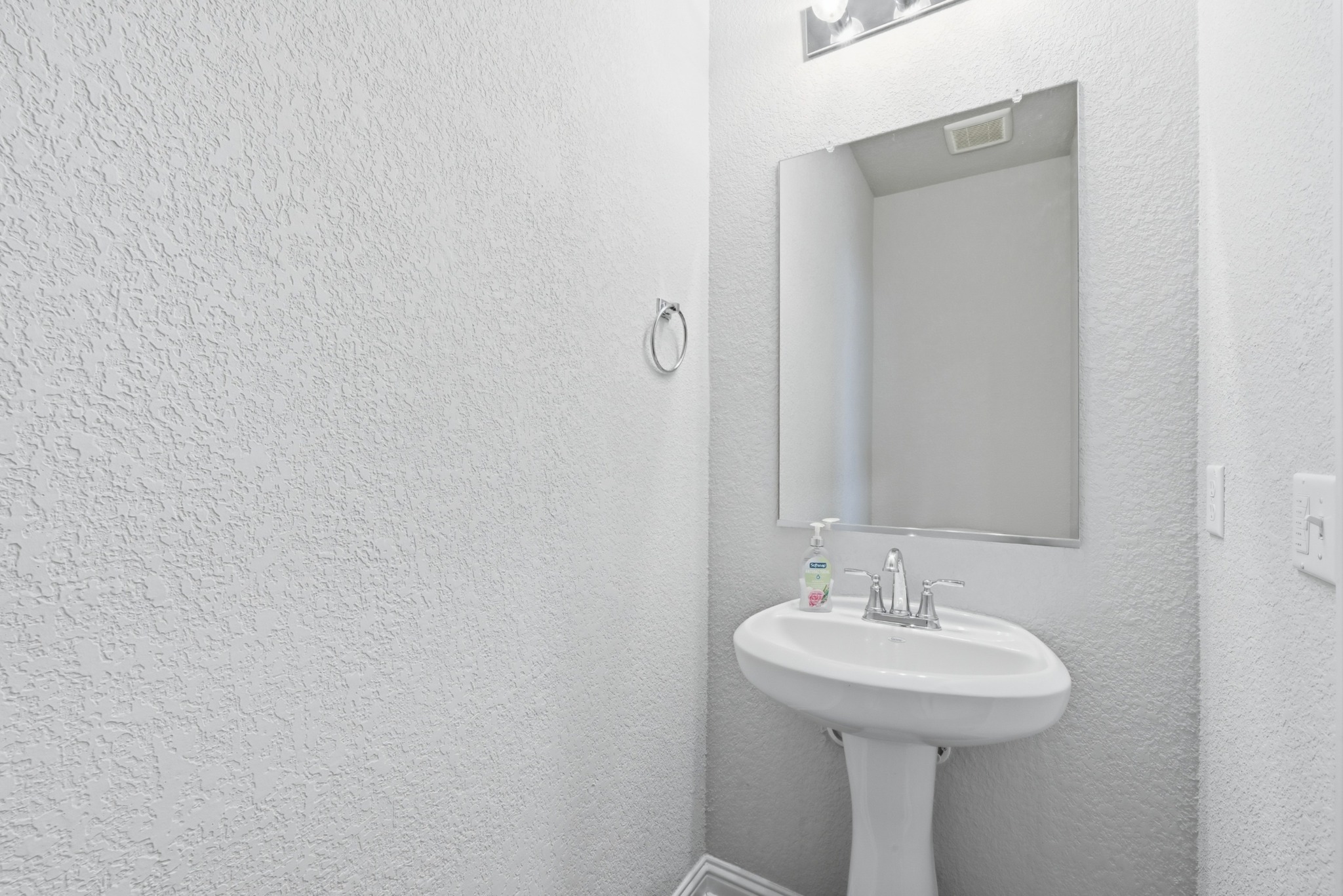 8201 Frida Bend Austin, TX 78744 - Photo 19 of 29 A well-appointed half-bath offers essential functionality with clean lines and a convenient pedestal sink.