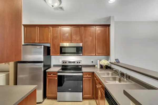a kitchen with a refrigerator stove and sink