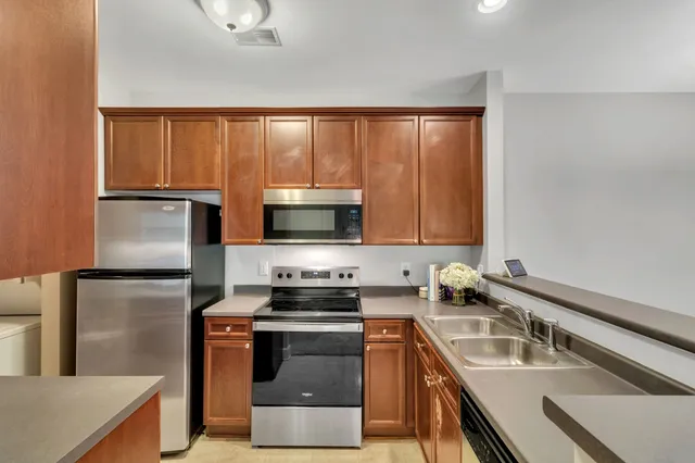 a kitchen with a refrigerator stove and sink