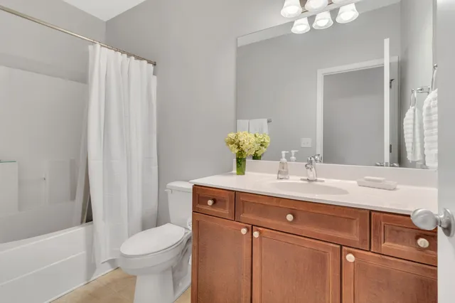 a bathroom with a sink vanity mirror and toilet