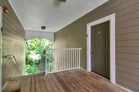 a view of balcony with wooden floor