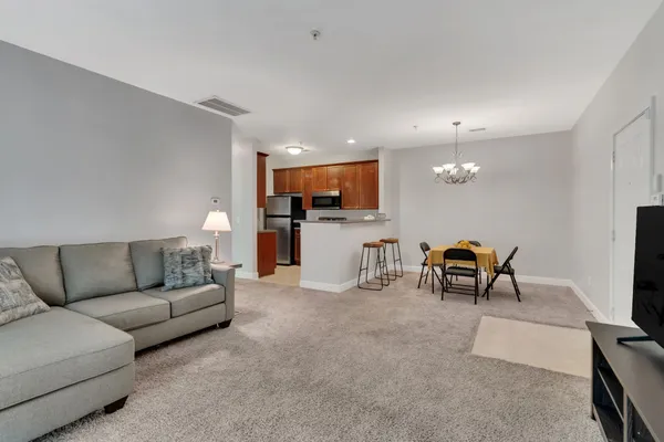 a living room with furniture and kitchen view