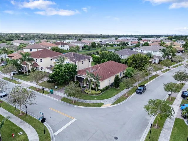 an aerial view of residential houses with outdoor space and street view