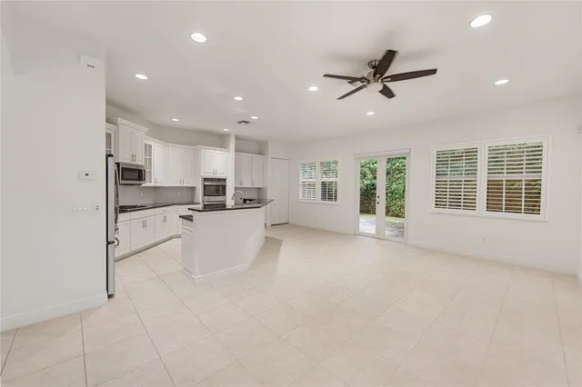 a view of kitchen with stainless steel appliances refrigerator oven and cabinets