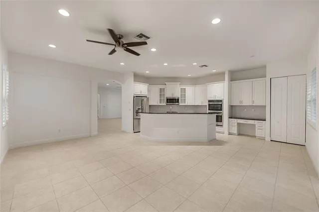 a view of kitchen with refrigerator and window