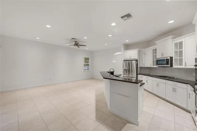 a kitchen with stainless steel appliances granite countertop a sink and cabinets