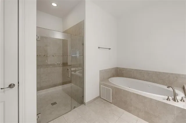 a bathroom with a bathtub and a shower