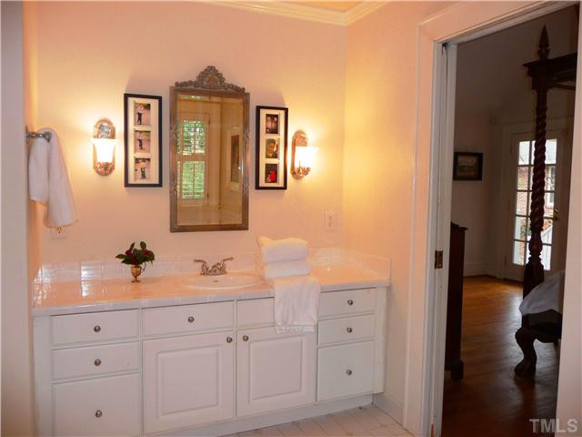 2324 Byrd Street Raleigh, NC 27608 - Photo 12 of 15 En suite master bath features a cedar lined closet, pocket door, large garden tub, walk-in shower, and separate pedestal sink with toilet that doubles as a half bath for guests. Master Bath/Spa