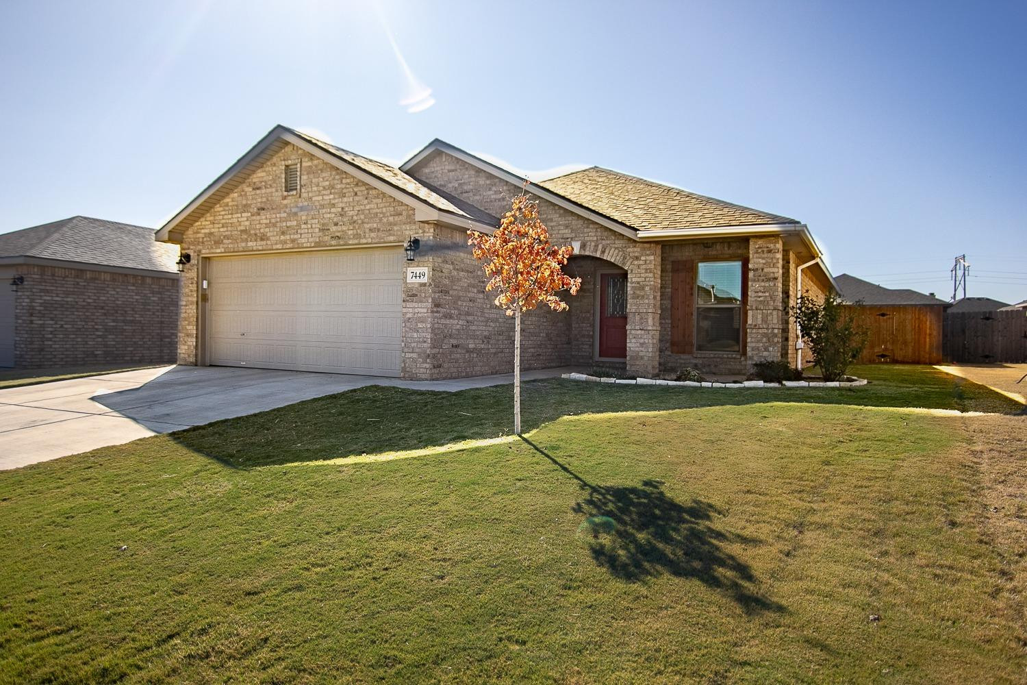 7449 104th Street Lubbock, TX 79424 - Photo 1 of 16 a house with trees in front of it