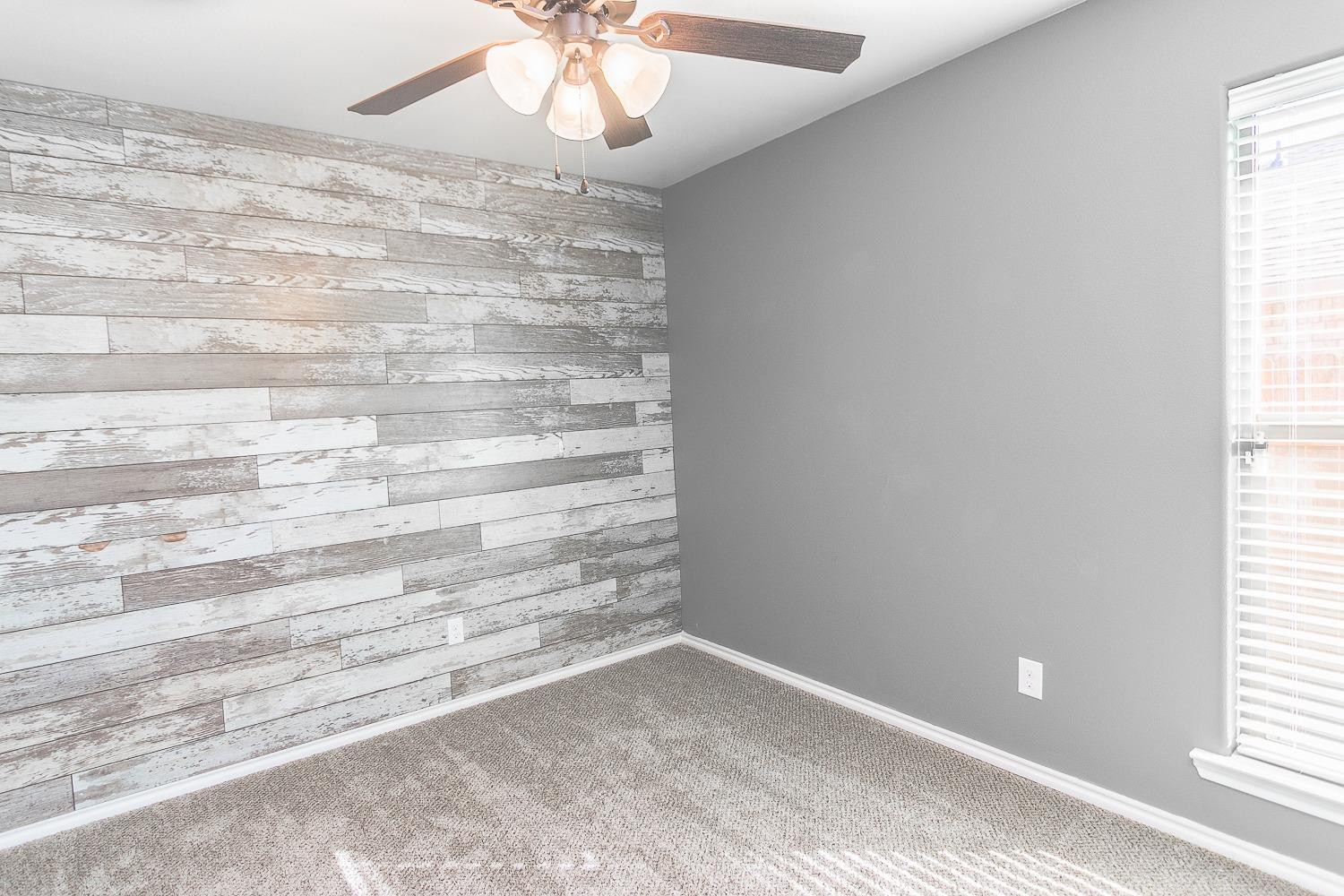 7449 104th Street Lubbock, TX 79424 - Photo 13 of 16 a view of room with window and hardwood floor