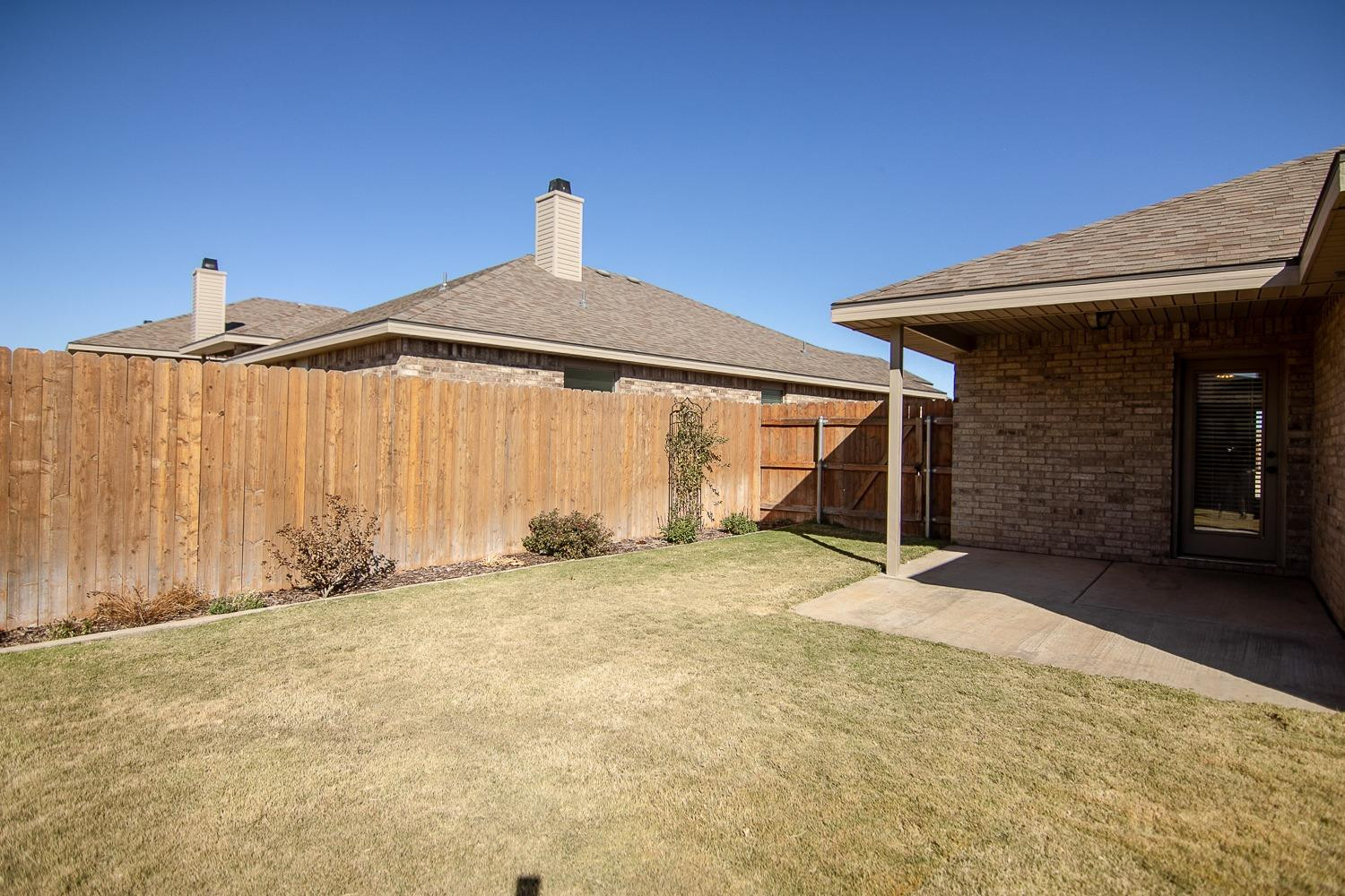 7449 104th Street Lubbock, TX 79424 - Photo 16 of 16 a front view of a house with a garage