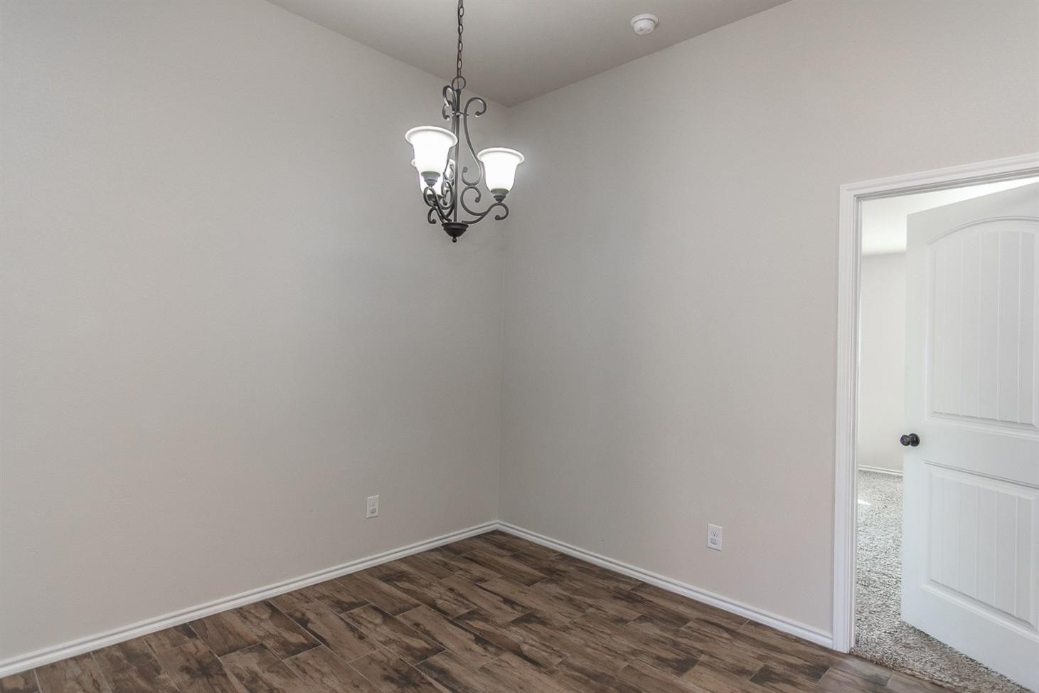 7449 104th Street Lubbock, TX 79424 - Photo 3 of 16 a view of empty room with wooden floor