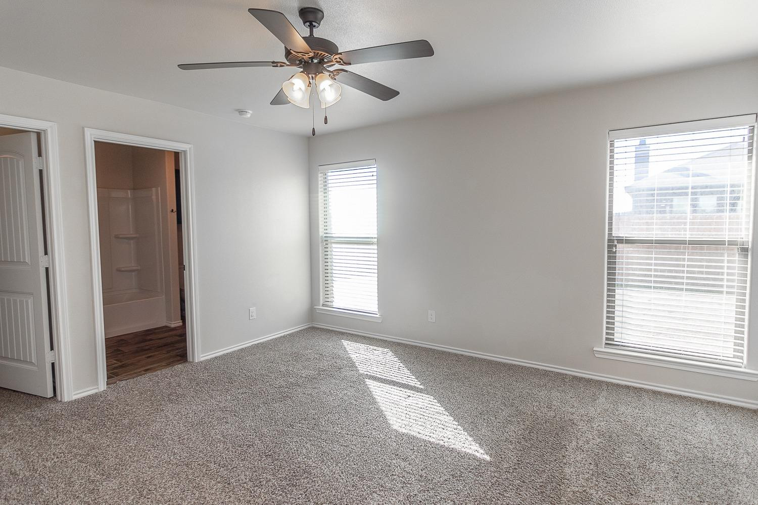 7449 104th Street Lubbock, TX 79424 - Photo 8 of 16 a view of an empty room with a window