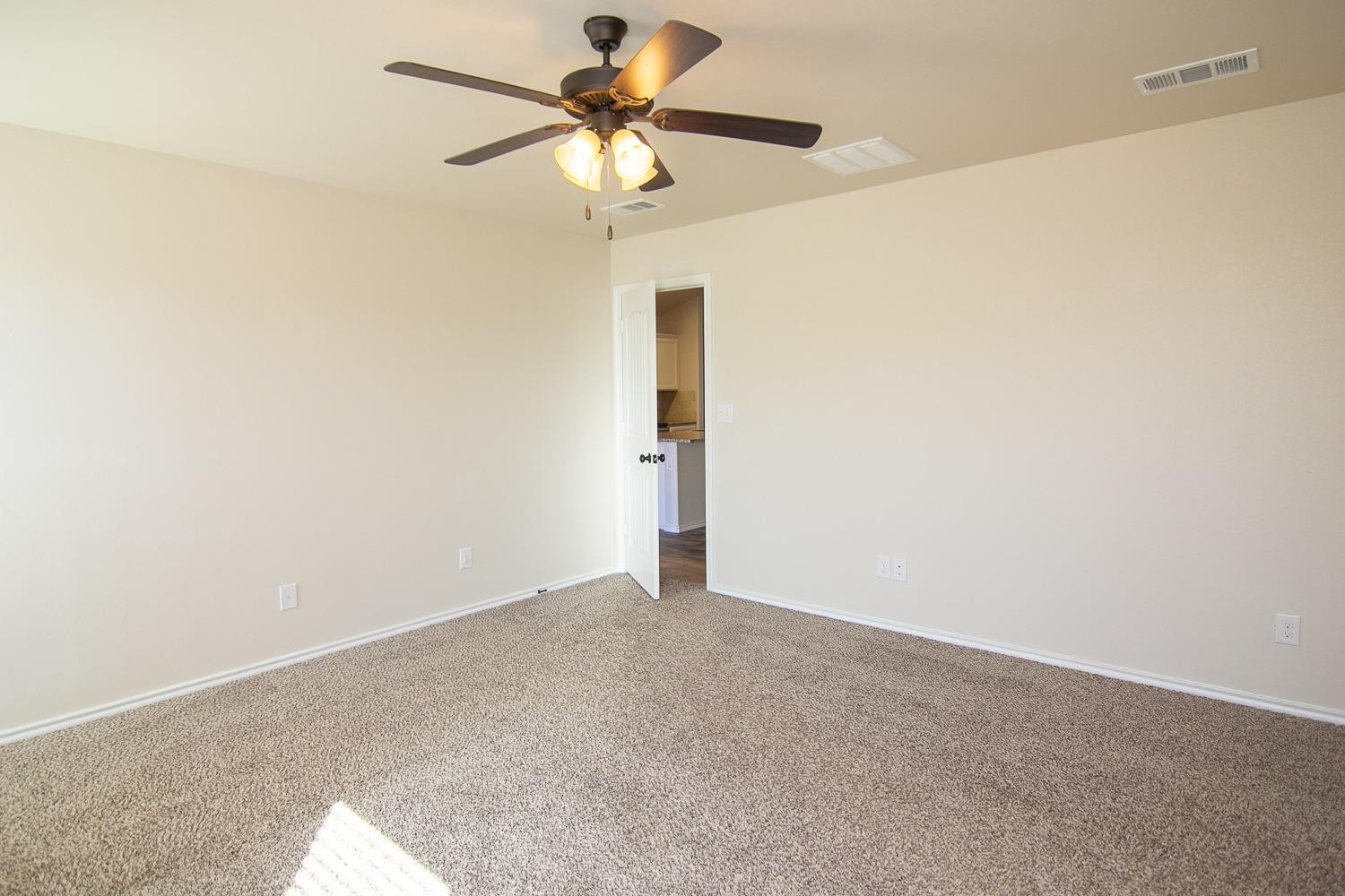 7449 104th Street Lubbock, TX 79424 - Photo 9 of 16 an empty room with a fan and a fan