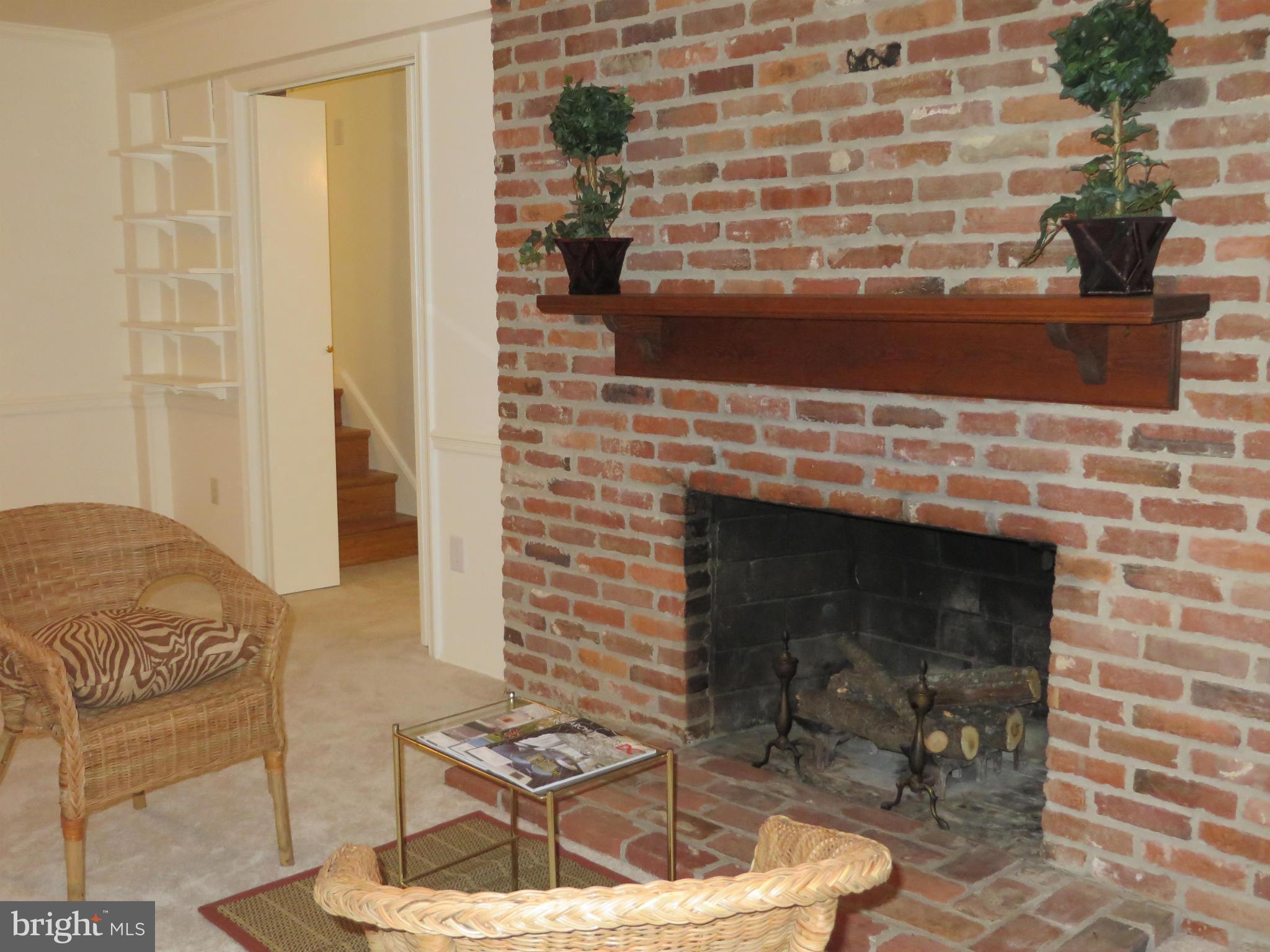 8425 Riverside Road Alexandria, VA 22308 - Photo 17 of 28 a fireplace with a vase and a chair