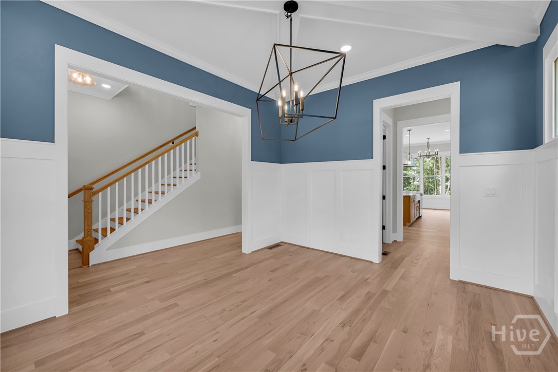 2476 St Martin Way Monroe, GA 30656 - Photo 5 of 75 Hardwood flooring complements the wainscoting and blue walls in the beautiful Dining Room