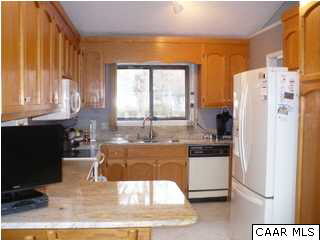 2 Laguna Road Palmyra, VA 22963 - Photo 7 of 31 a kitchen with stainless steel appliances granite countertop a refrigerator a sink and white cabinets