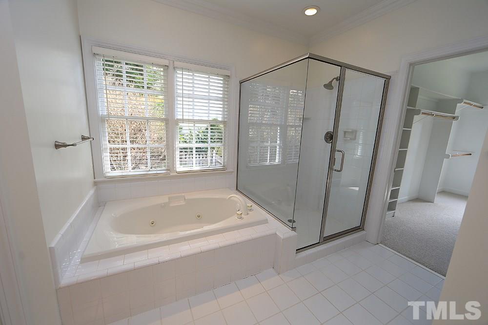 4428 Touchstone Forest Road Raleigh, NC 27612 - Photo 11 of 21 Renovated master bath with new shower enclosure and jetted tub.
