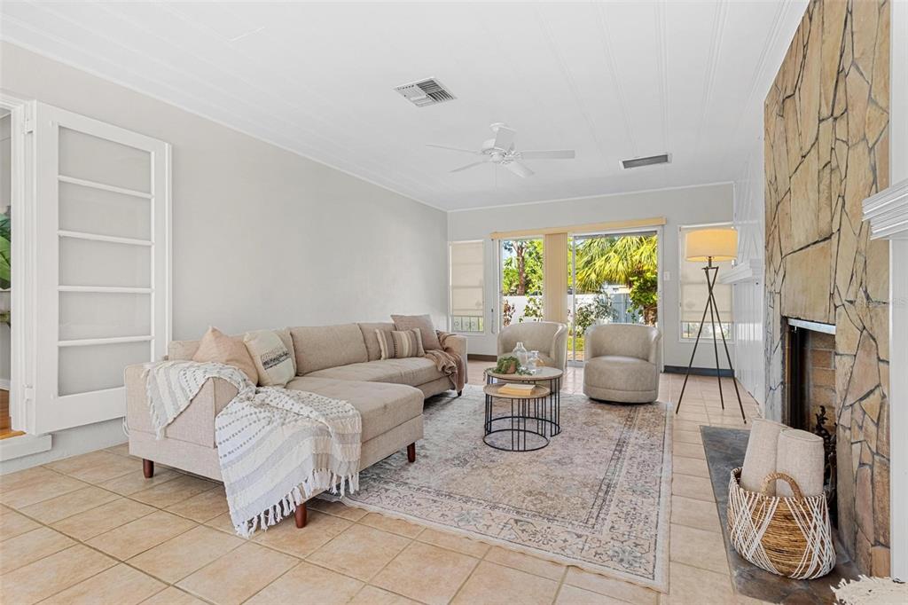 300 22nd Avenue South St. Petersburg, FL 33705 - Photo 30 of 82 a living room with furniture a flat screen tv and a large window