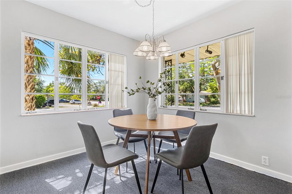 300 22nd Avenue South St. Petersburg, FL 33705 - Photo 44 of 82 a view of a dining room with furniture a chandelier and wooden floor