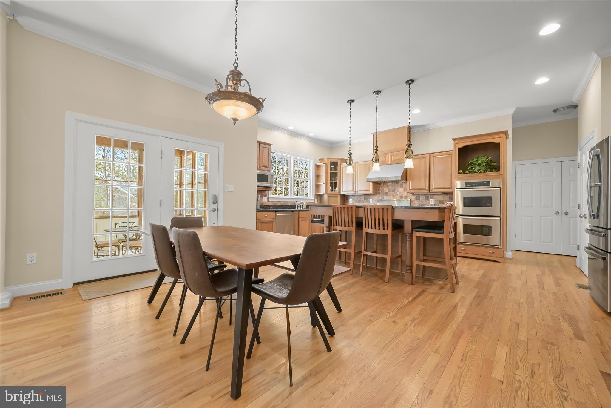 7016 Meandering Stream Way Fulton, MD 20759 - Photo 15 of 86 a view of a dining room with furniture window and wooden floor