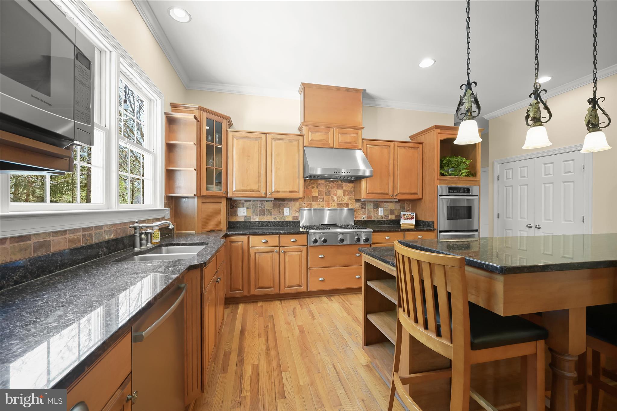 7016 Meandering Stream Way Fulton, MD 20759 - Photo 20 of 86 a kitchen with stainless steel appliances granite countertop a stove a sink and a wooden floors